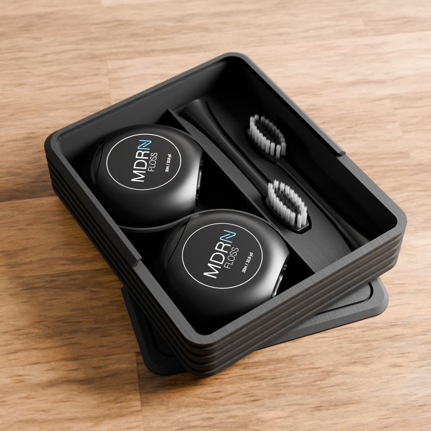 Compact black tray with floss and brushes