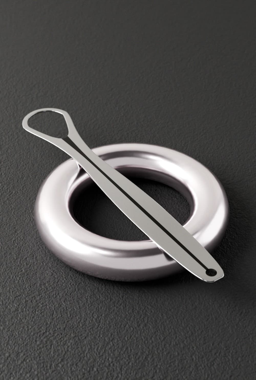 Metal tongue scraper displayed on a dark surface